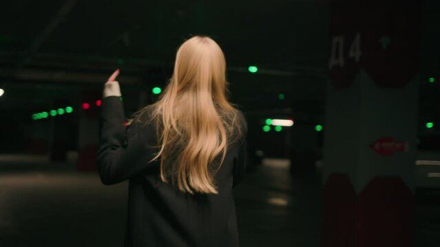 Mad stressed angry woman businesswoman client driver walk in underground car parking shout mobile phone call taxi bad service back view unrecognizable girl scream talk cellphone quarrel conflict swear