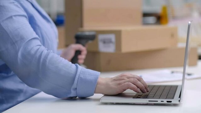Close up laptop woman checking orders and scanning barcode on cardboard boxes and packages ready for shipping. online marketplace, dropshipping sales and delivery.