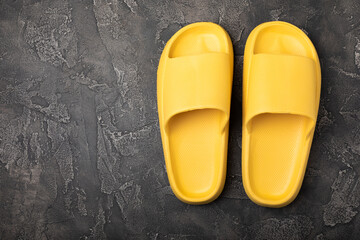 Home slippers on a black marble background. Indoor shoes. Flatley. Home cozy slippers for comfort. Close-up. Place for text. Copy space.