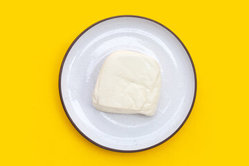 White tofu on yellow background