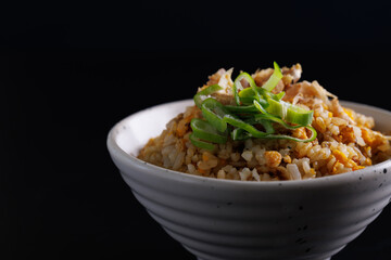 Japanese fried rice yakimeshi isolated in black background