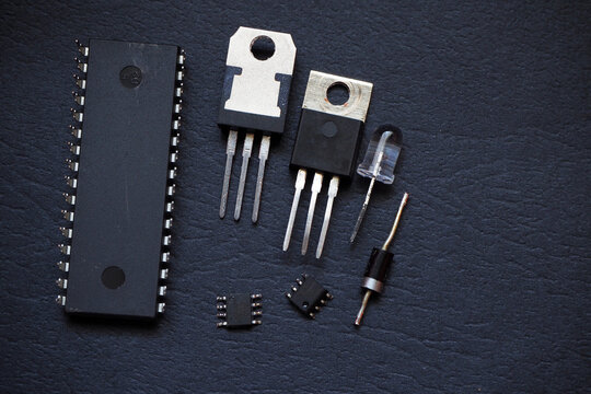 Semiconductor components. Integrated circuit, microchips, transistor, thyristor, voltage regulator,diode, and LED isolated on a black.