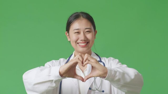 Close Up Of Asian Woman Doctor With Stethoscope Pray For Something On Green Screen Background In The Hospital
