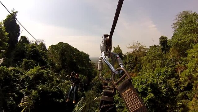 guy traveler jumps and flies on a bungee cord. Zipline flying extreme sports, thailand