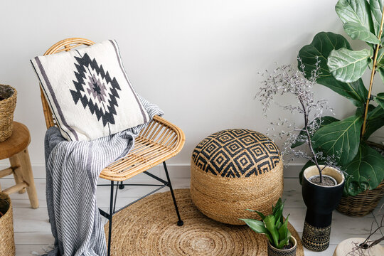 boho style in apartment with houseplants and wicker furniture