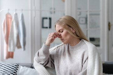young female suffering from sinus infection, staying sick at home - obrazy, fototapety, plakaty