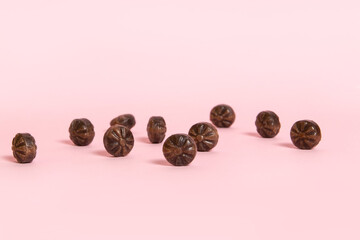 Hard coffee candies on pink background