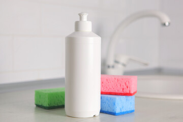 Dishwashing detergent on the background of the kitchen