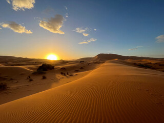 Fototapeta na wymiar Merzouga, Morocco, Africa, panoramic view of the dunes in the Sahara desert, grains of sand forming small waves on the beautiful dunes at sunset 