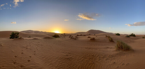 Merzouga, Morocco, Africa, panoramic view of the dunes in the Sahara desert, grains of sand forming small waves on the beautiful dunes at sunset 

