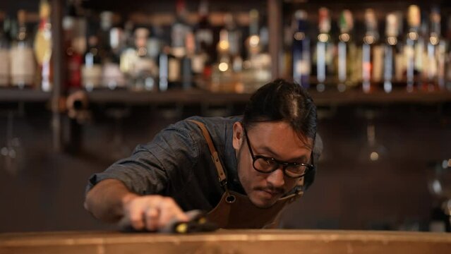 Night club concept of 4k Resolution. Asian staff cleaning the restaurant before getting ready to open. A group of specialized clubs that sell alcoholic beverages.