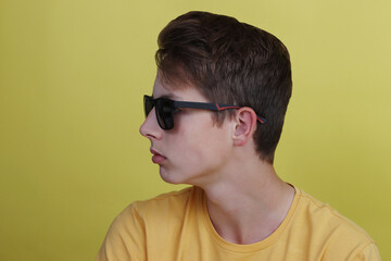 Fototapeta premium Stylish boy teenager close-up in glasses.