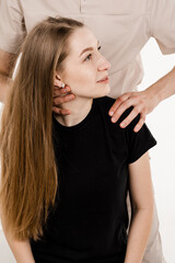 Orthopedist examining female neck and head. Manual correction of the ridge and cervical region. Rehabilitation therapy on white background. Manual therapy at physiotherapist or chiropractor.