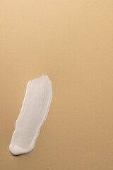 Close up of white paint stripe on beige background with copy space