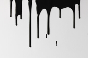 Close up of black paint shapes on white background with copy space