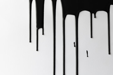 Close up of black paint shapes on white background with copy space