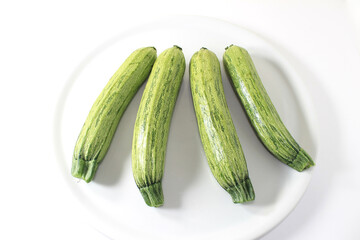 close-up of some zucchinis on a white background