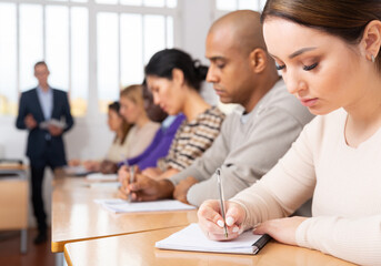 Students listening task for exam in the classroom