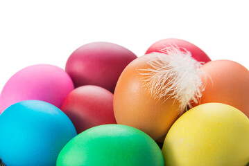 Bright multi colors Easter eggs with hen feather isolated on white background.