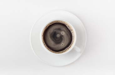 A white cup of coffee on a white background. Morning coffee. Top view.