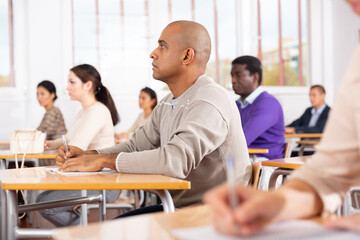 Portrait of a student at a desk in a university audience
