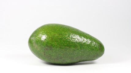 close up of a whole avocado on a white background