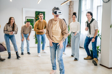 One woman in front group of friends enjoy virtual reality VR headset