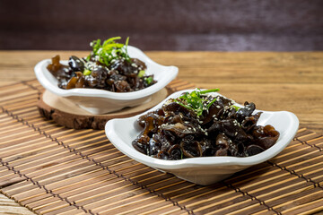 with cCold Black Fungus hopsticks served in dish isolated on mat top view on wooden table Hong Kong food