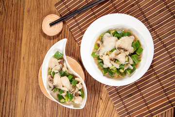 Stir-Fried Snapper Fillets with Gumbo Lily with chopsticks served in dish isolated on mat top view on wooden table Hong Kong food