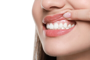Woman showing healthy gums on white background, closeup. Space for text