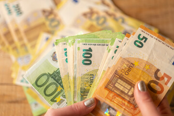 euro banknotes.Money counting. Recalculation of money.Counting euro banknotes.Hands recalculate banknotes.Expenses and incomes in European countries.pack of money in a hand close -up.
