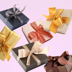 Many beautiful gift boxes falling on pastel pink background
