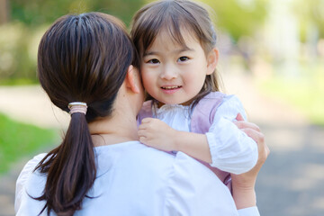 女の子を抱きしめるお母さん