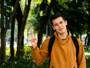 young man pointing a finger at empty space for text