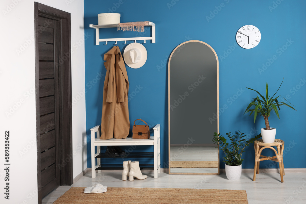 Sticker Stylish hallway with shoe storage bench and mirror near blue wall. Interior design