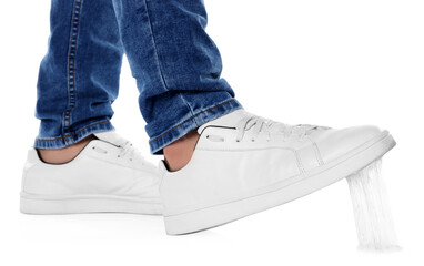 Person stepping into chewing gum on white background, closeup