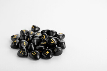 Pile of black rune stones on white background