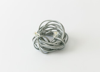 Telephone line cord heavy duty silver satin 4 conductor on white background.