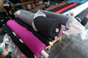 Interior of an industrial warehouse with fabric rolls samples. Small business textile colorful...