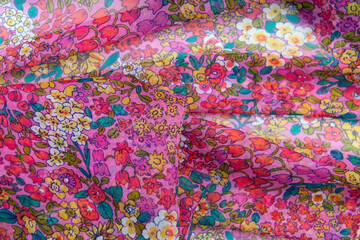 Collection of fashionable fabrics. Samples of different natural fabrics for sewing a fashion collection of clothes. Large selection of fabrics in the store or tailor warehouse.