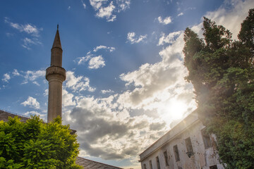 Minaret and cloudy sky view in famous town Mostar, Bosnia and Herzegovina - 589367842