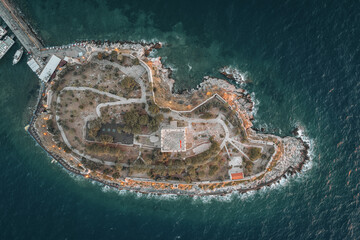 Aerial sunset view of Kusadasi castle, historical place with a lighthouse in Turkey - 589368005