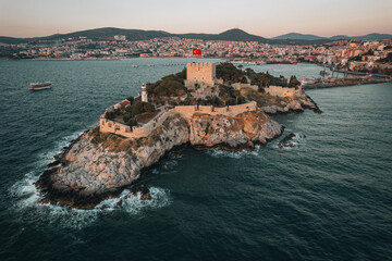 Aerial sunset view of Kusadasi castle, historical place with a lighthouse in Turkey - 589368011