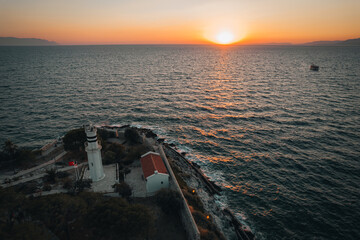Aerial sunset view of Kusadasi castle, historical place with a lighthouse in Turkey - 589368023