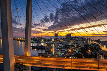 Aerial sunset view of Vladivostok city center and Golden horn bay with a famous bridge - 589368034
