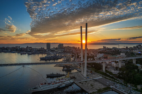 Aerial sunset view of Vladivostok city center and Golden horn bay with a famous bridge