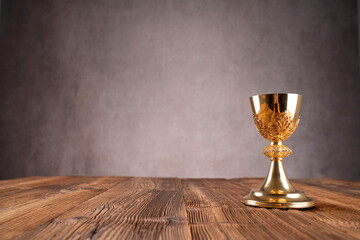 Catholic religion concept. Easter.The monstrance and golden chalice on gray background. 