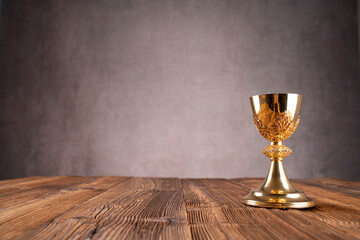 Catholic religion concept. Easter.The monstrance and golden chalice on gray background. 