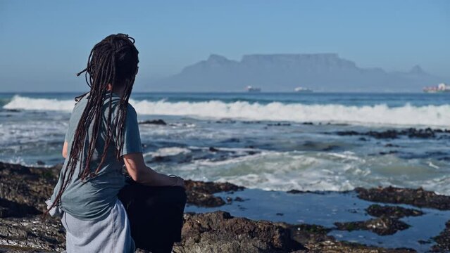 Woman seen sitting and watching table mountain