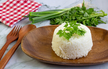 Cooked plain white rice (Jasmine rice) served in a wooden plate